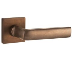 Deurkruk op geveerd rozet verdekt Padania messing antiek brons